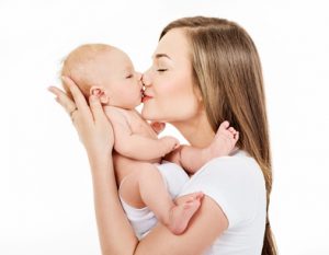 Mother and baby playing and smiling. Happy family.