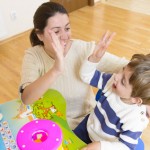 Mother playing with her child and encouraging him