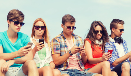 group of friends with smartphones outdoors